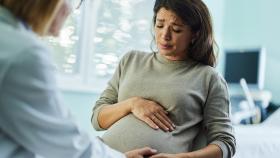 Pregnant Woman with Concerned Facial Expression