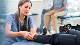 Clinical Practitioner Treating a Patient's Ankle