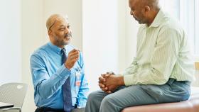 Physician speaking with a male patient Physician speaking with a male patient