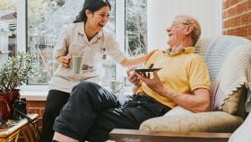 At home provider laughing with her patient At home provider laughing with her patient