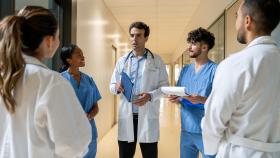 Physician huddling with his clinical team Physician huddling with his clinical team