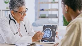 Physician displaying a CAT scan of the brain Physician displaying a CAT scan of the brain