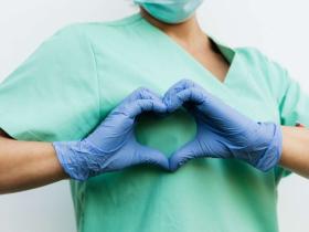 Healthcare Professional Forming a Heart with Gloved Hands Healthcare Professional Forming a Heart with Gloved Hands