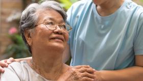 An older lady being comforted. 