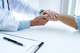 Medical Advice A doctor holding a patient's hand