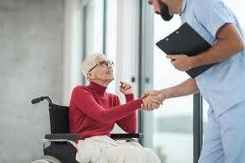 Nurse greeting patient in wheelchair