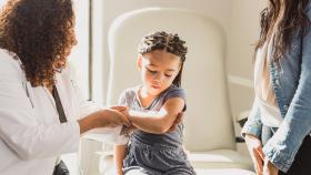 Physician examining a child's arm