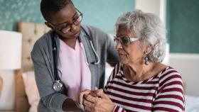 Clinician caring for Parkinson's patient Clinician caring for Parkinson's patient