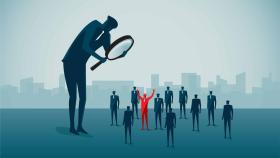 Individual holding magnifying glass identifying another individual