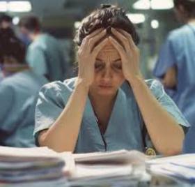 Healthcare worker holding her head 