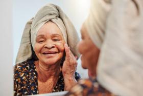 Elderly Woman Checking Her Skin in the Mirror