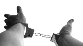 arms raised in handcuffs 