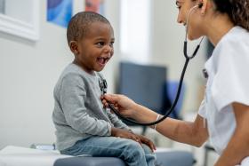 healthcare provider using stethoscope to listen to little boy's heart 