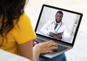 Patient Having a Virtual Meeting with a Physician on a Computer Patient Having a Virtual Meeting with a Physician on a Computer