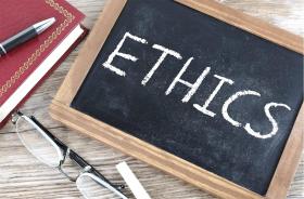 chalk board with the word "Ethics" written on it. 