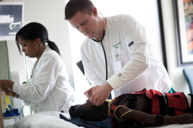 Pair of Clinicians Performing a Simulation on a Child Mannequin