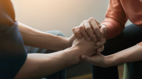Two people holding hands