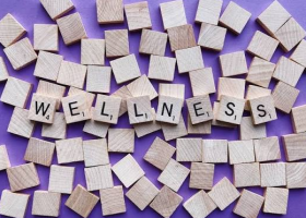 The Word "Wellness" Spelled out in Wooden Scrabble Pieces
